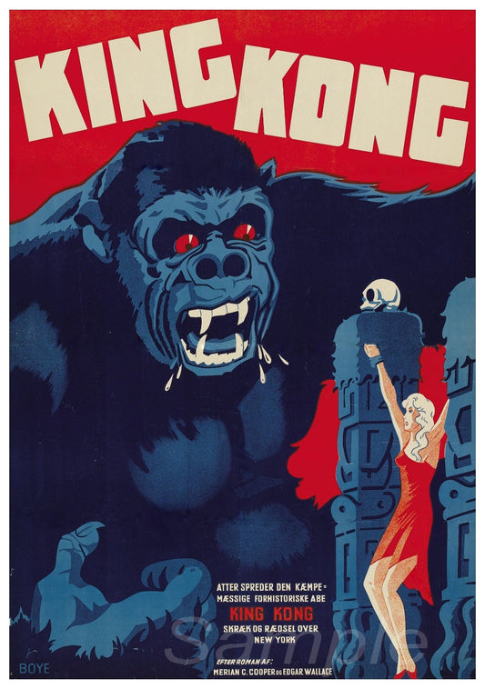 A vintage movie poster print of King Kong with a red-eyed gorilla-like creature standing atop a building, with a person in a red dress hanging from his fingers.