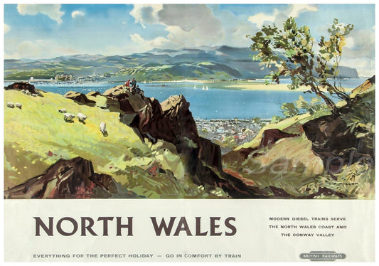 A vintage railway poster print featuring a scenic view of North Wales with a green field, sheep, and a body of water in the background, titled 'NORTH WALES' and 'EVERYTHING FOR THE PERFECT HOLIDAY'.