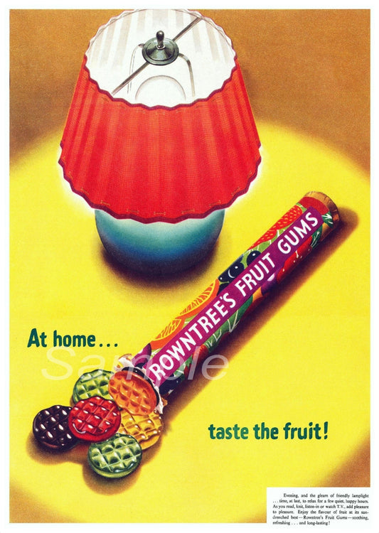 A vintage-style poster of Rowntree's Fruit Gums with a colorful candy bar design, lamp, and text 'At home.
