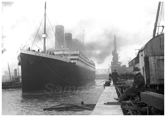 A vintage black and white poster of the Titanic ship docked at a port, with a person sitting on the dock looking towards the ship.