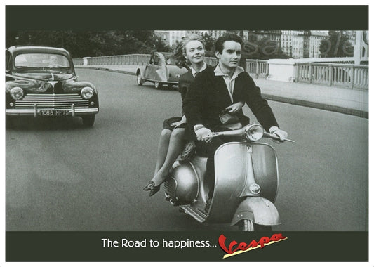 A vintage advertisement poster of a man and woman riding a Vespa scooter with the text 'The Road to Happiness... Vespa'.