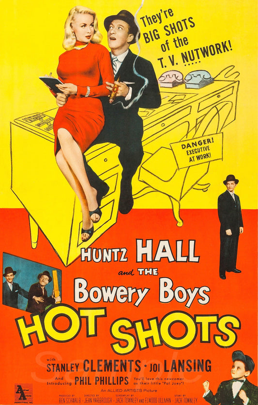 Vintage movie poster for 'Hot Shots' featuring a man and woman on a desk with text about TV network.