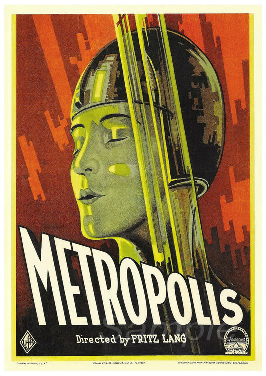 A vintage movie poster print of the 1927 film 'Metropolis', depicting a stylized, artistic rendering of a female figure in a metallic helmet against a red and orange background.